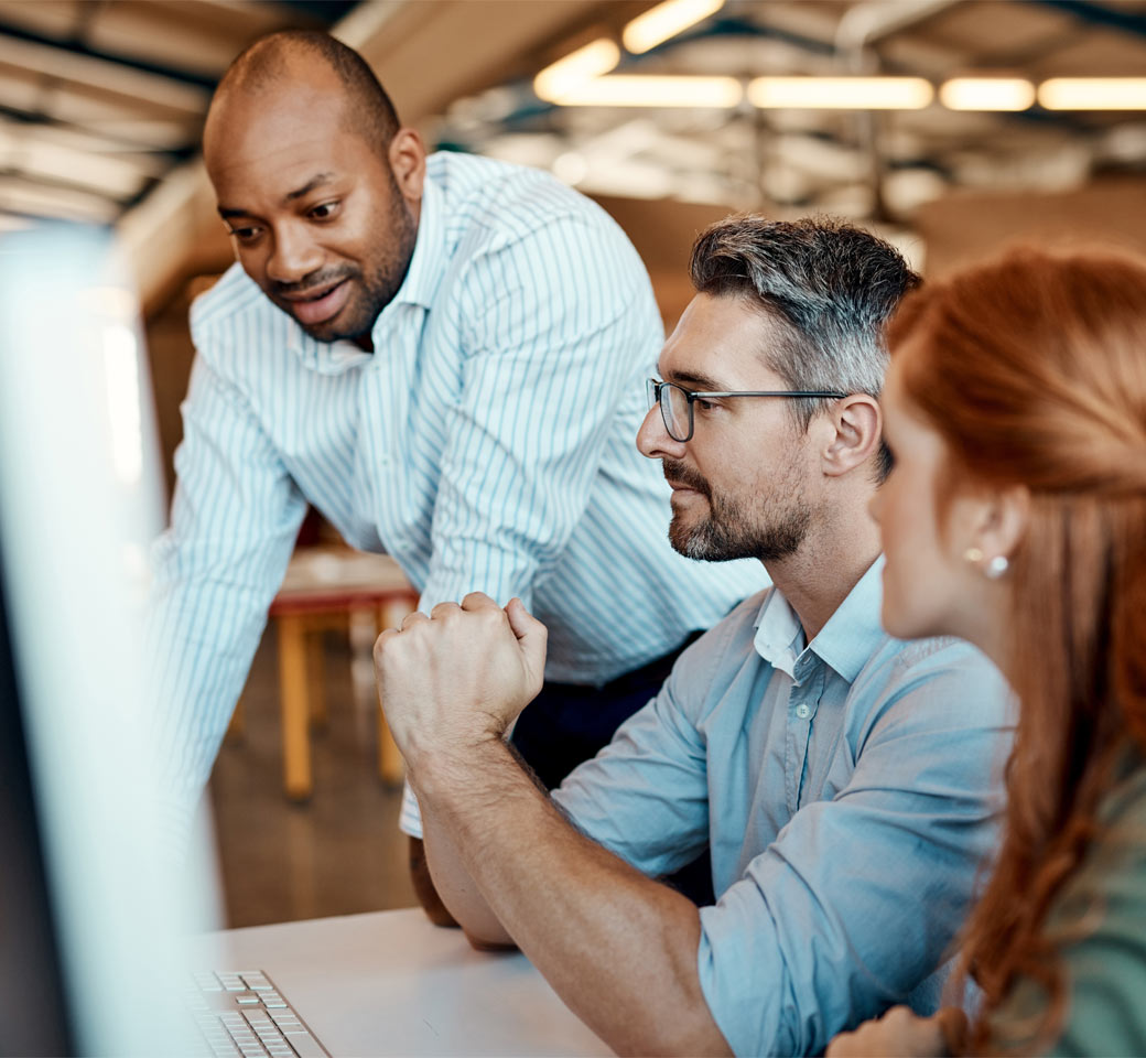Image of people working together at a computer