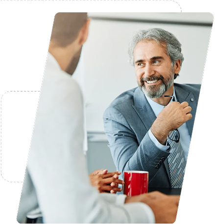 Two business professionals smiling and discussing supply chain topics.